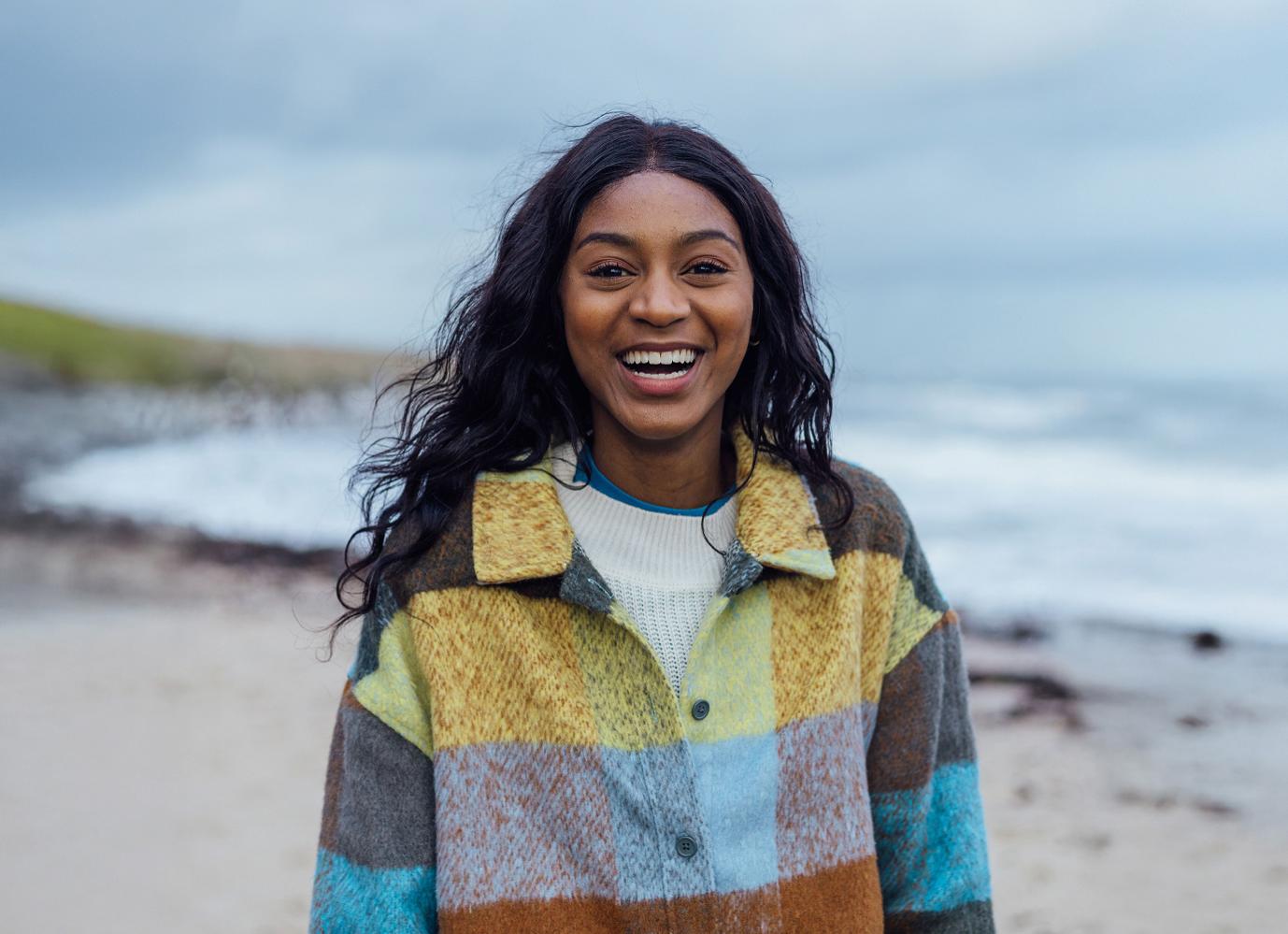A smiling woman on a beach