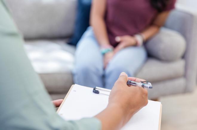 A woman with a clipboard and pen