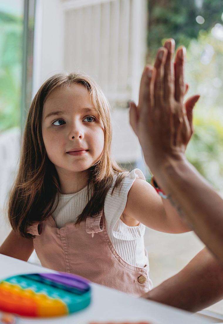 A girl and a woman high fiving