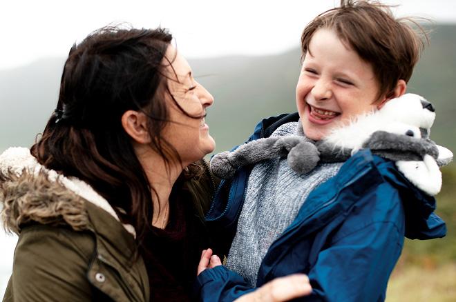 A woman and a child smiling