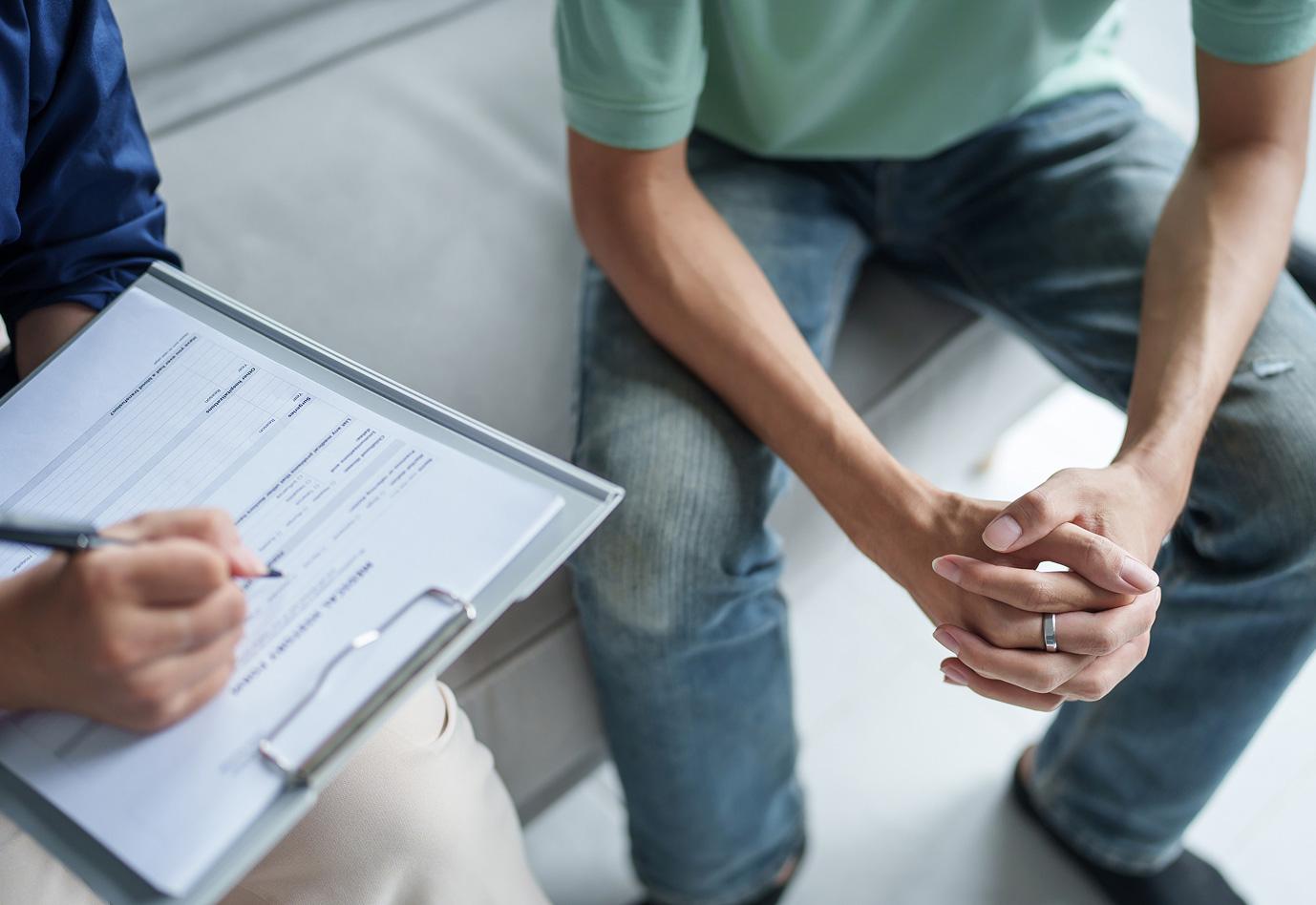 Two people filling out a form together