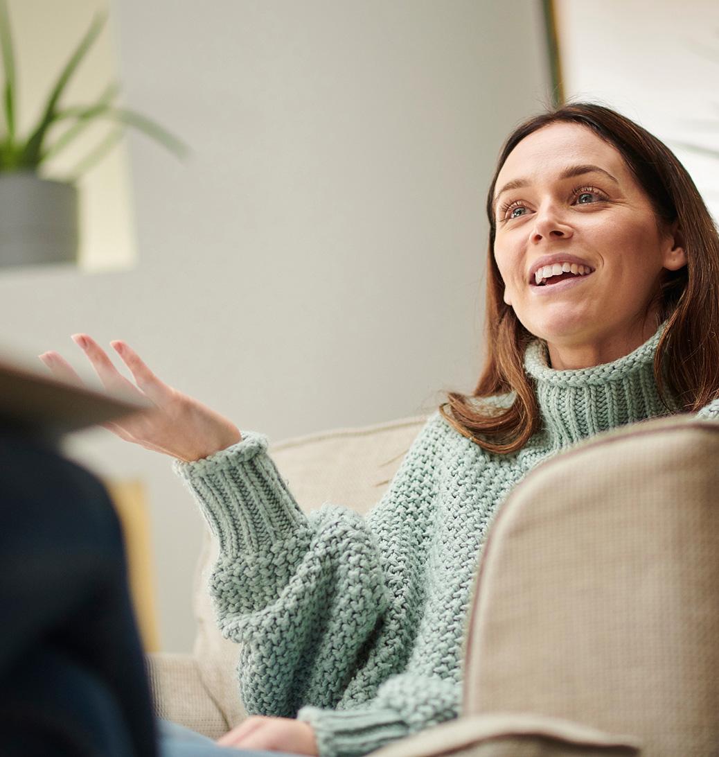 A smiling woman on a sofa